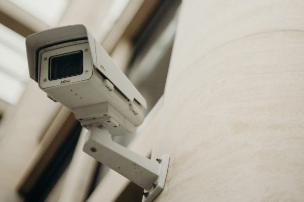 A security camera mounted on a building pillar
